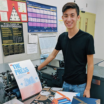 A student with a letterpress