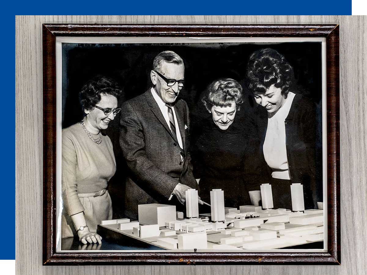 Audrey Bowes (left) with Principal Howard Kerr and colleagues view a model for ‘the future Ryerson’.