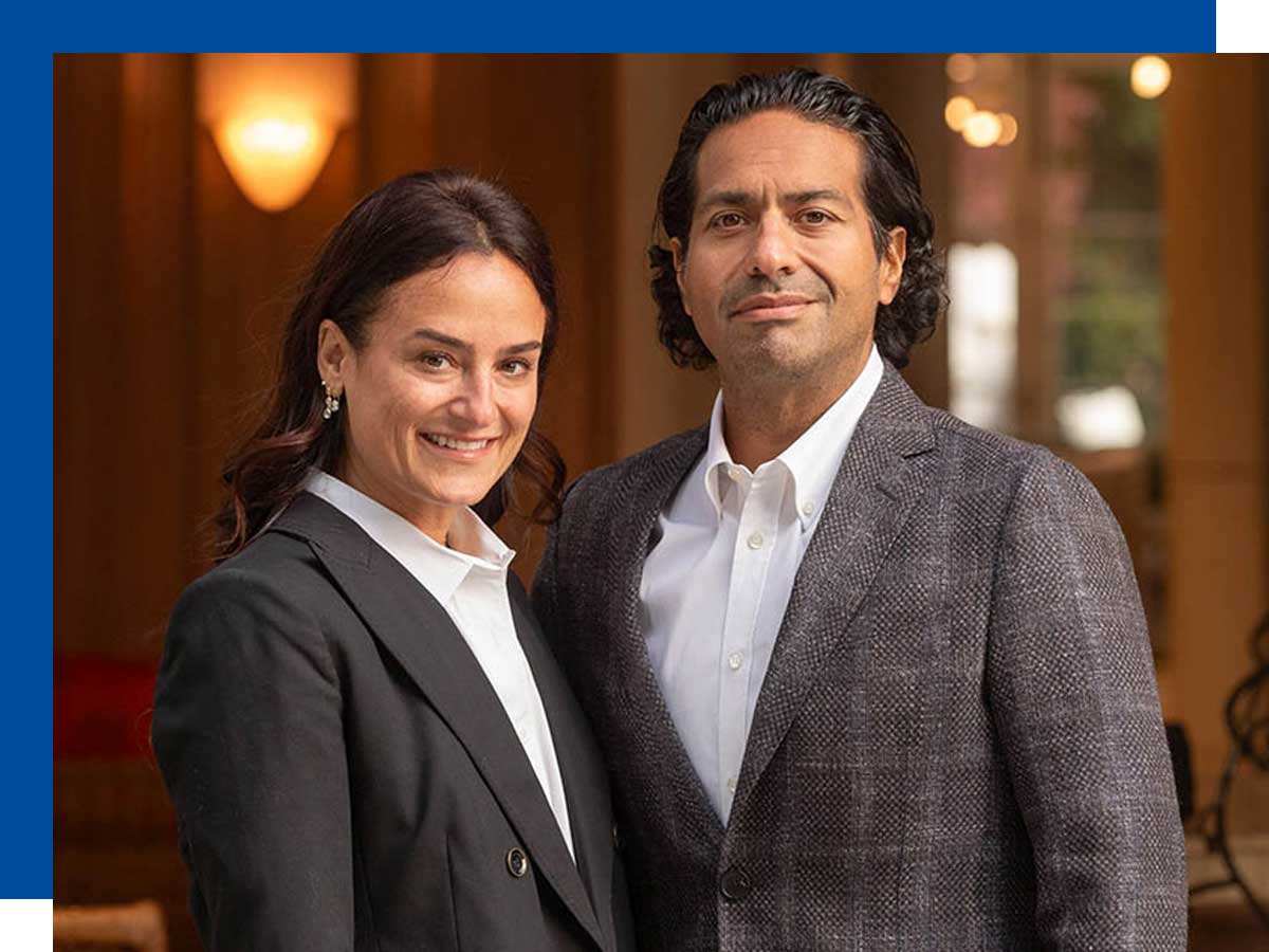  A man and woman look into the camera smiling.