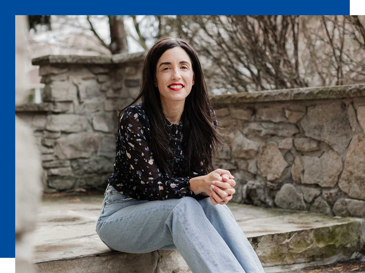 Woman sits on a stone step. Photo by Amanda Sarah Cherish