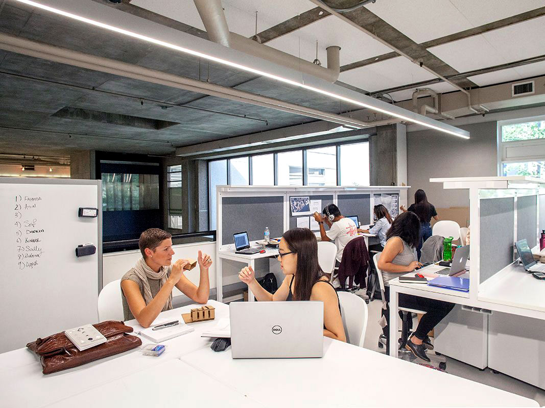 Instructor and students working in the new studio space