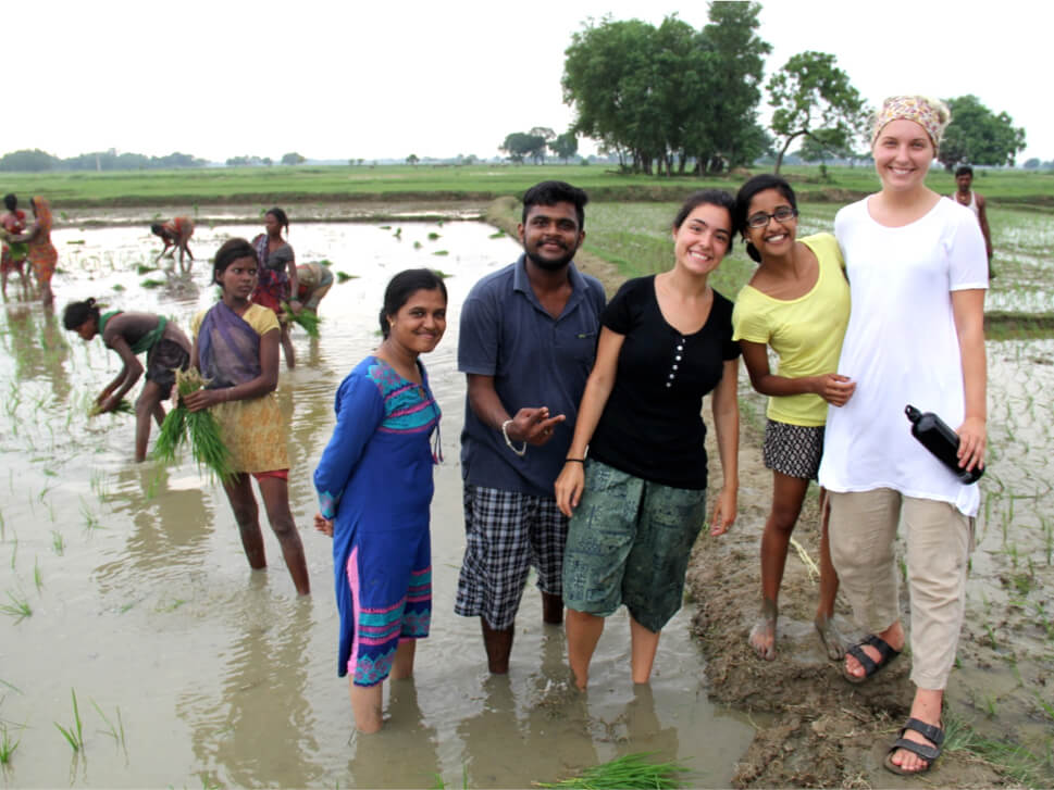 Chantal and Nickza pose with Indian students on the field.