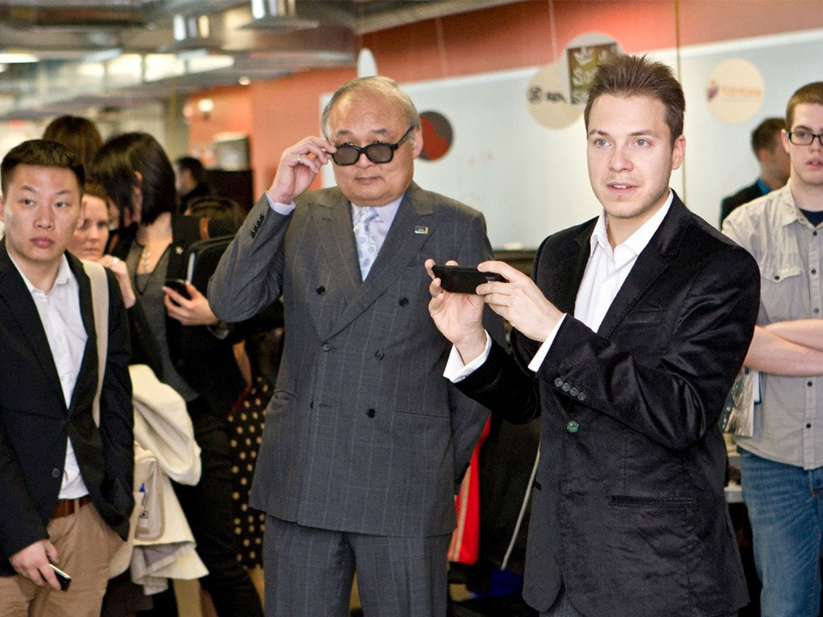 G. Raymond Chang pulls down his sunglasses as he tours Toronto Metropolitan University.