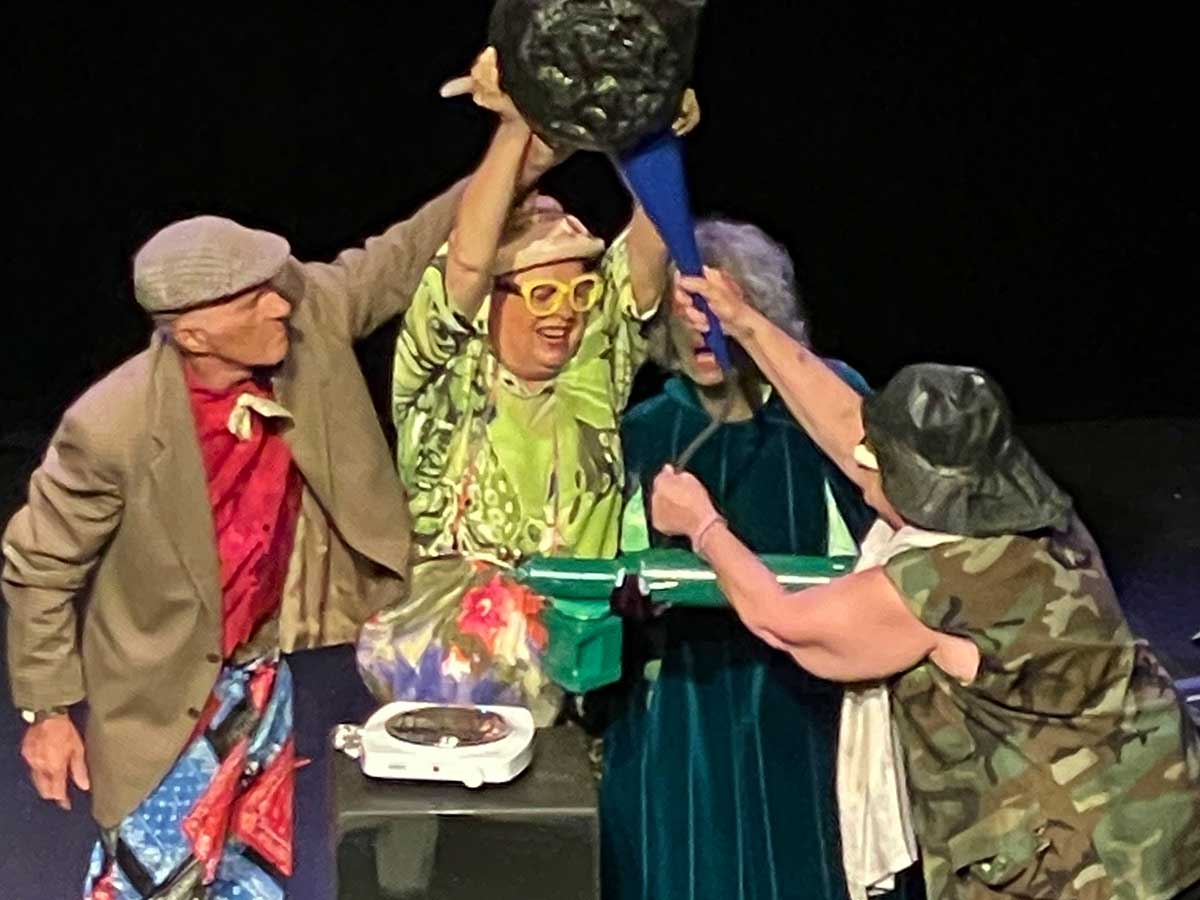 Three student actors aged 50-plus perform on stage.