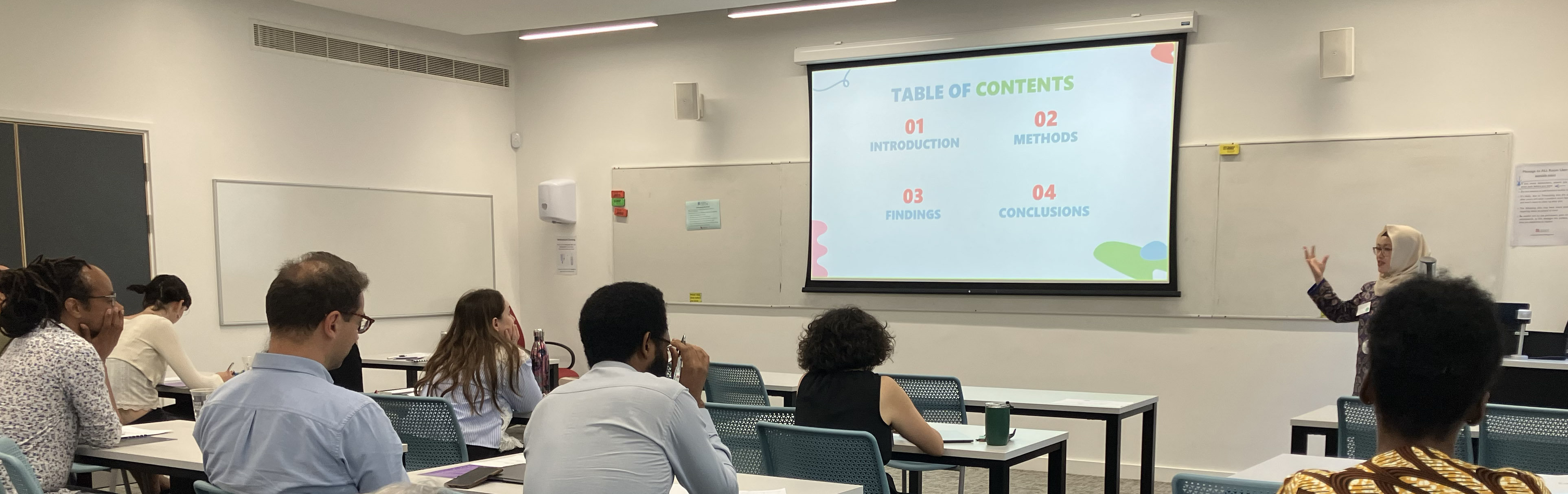 Michelle Andrina speaking to a room of people at the University of Bristol, UK