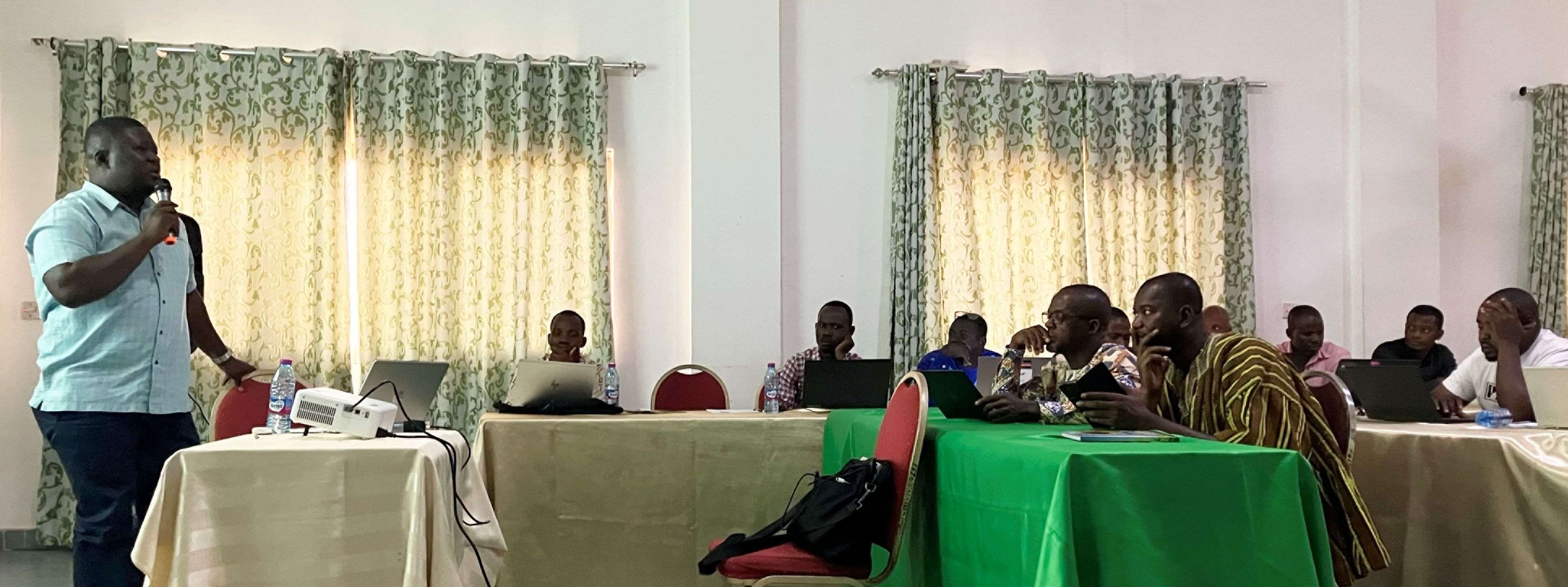 Abdul-Rahim Mohammed speaking to a room of people at the Getfund Guest house