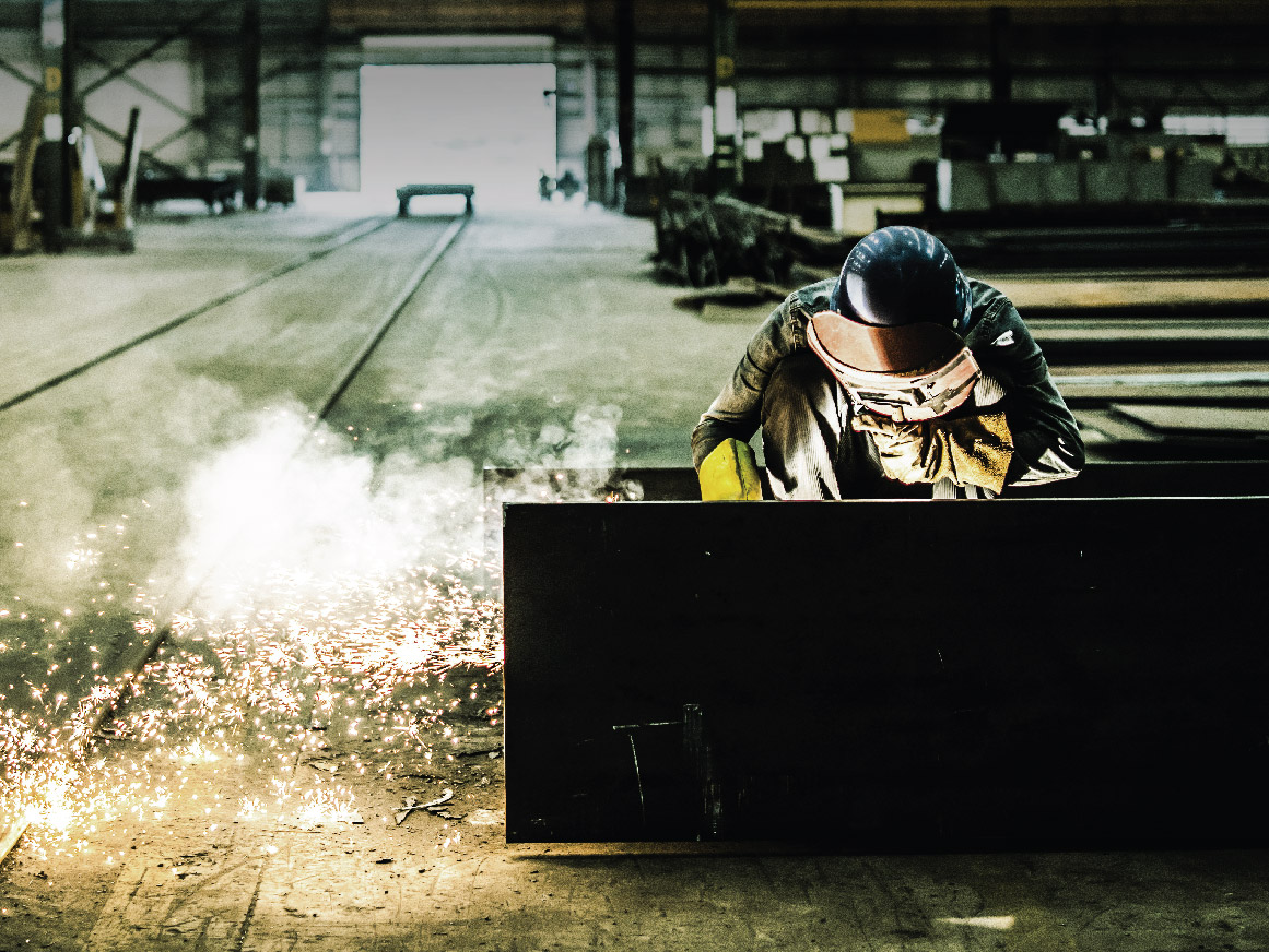 Welder welding in a warehouse