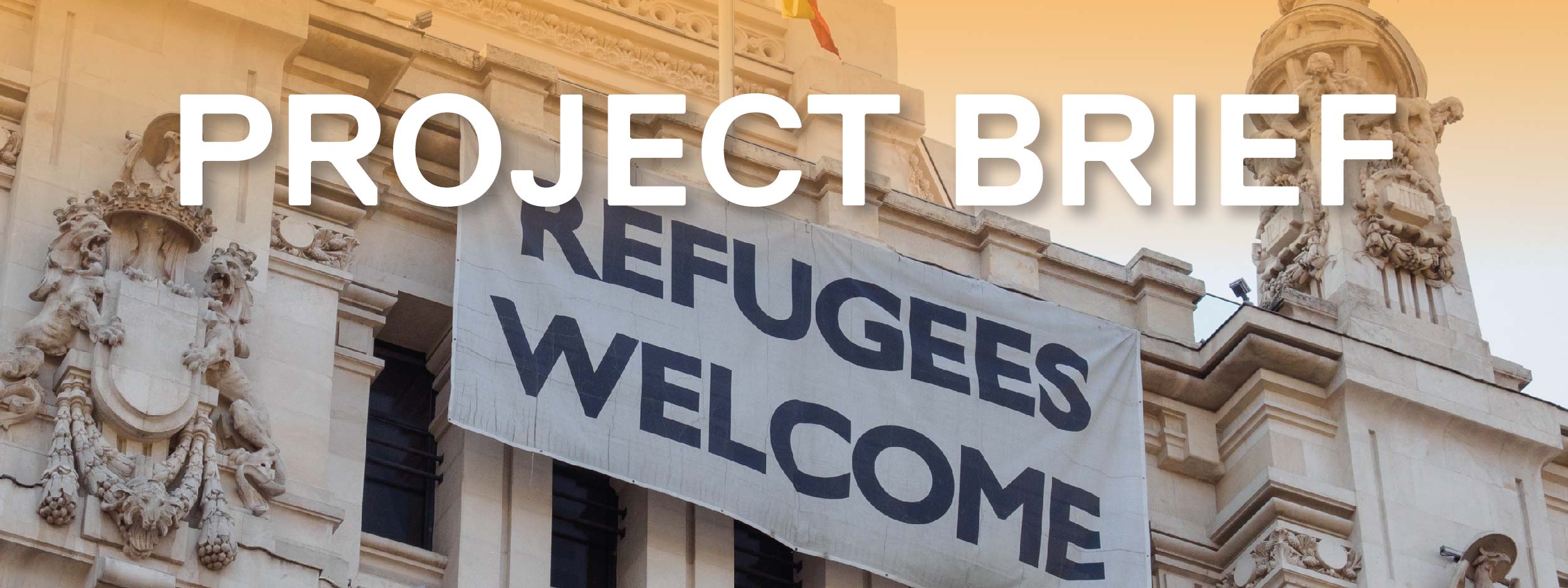 Sign welcoming refugees next to the Spanish flag on the facade of Palacio de Cibeles, Madrid, Spain