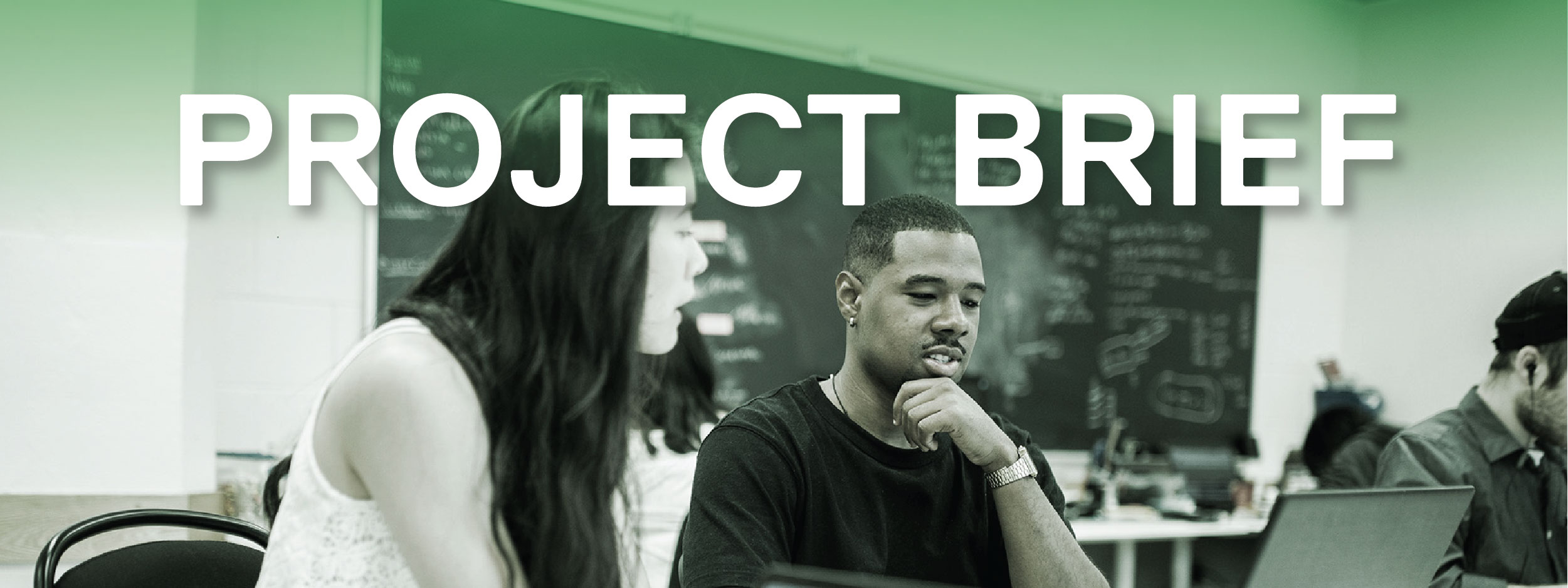 Students sitting in a classroom on their laptops
