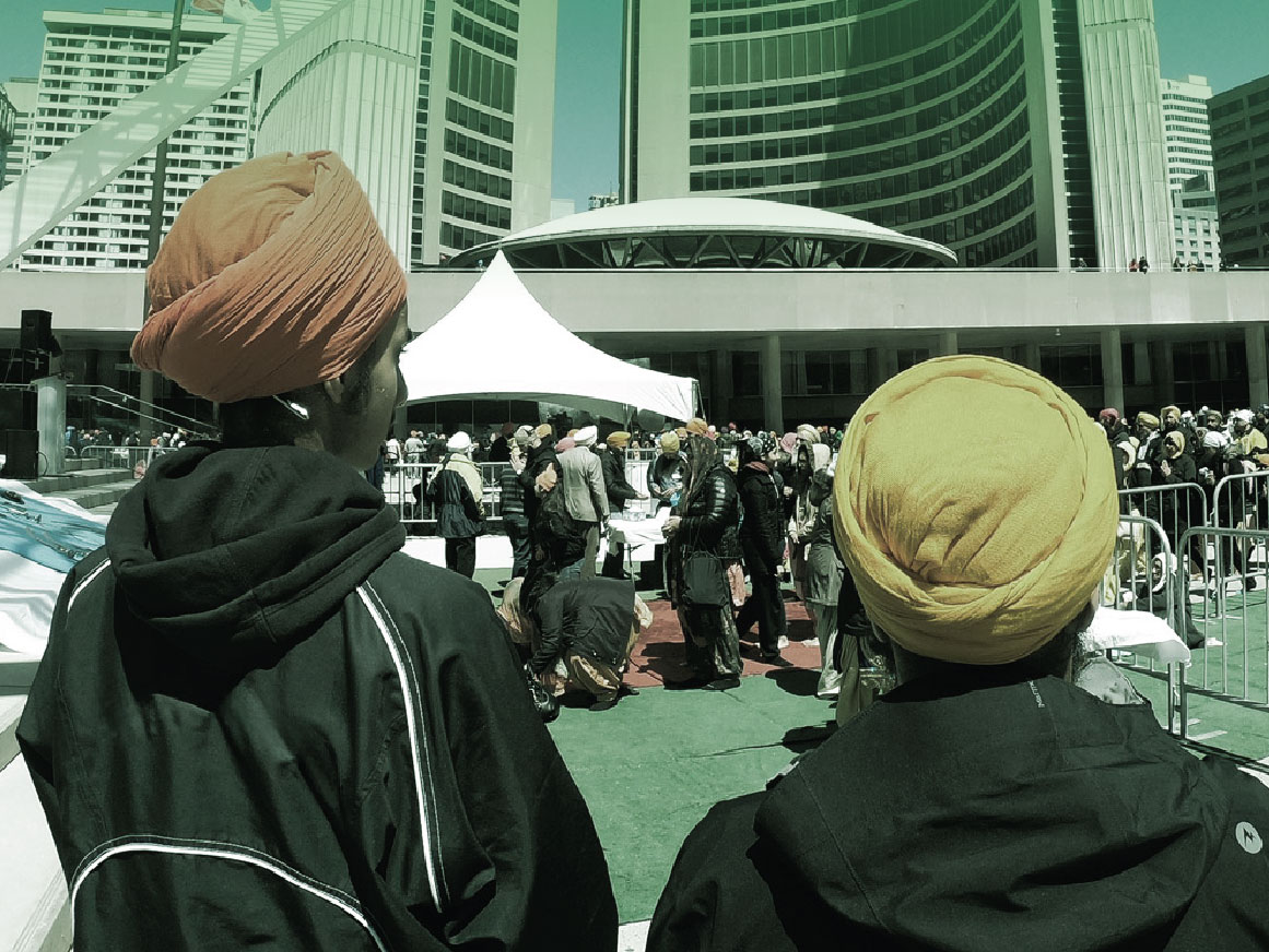 Two men enjoy a cultural event at Nathan Phillips Square in Toronto, Canada