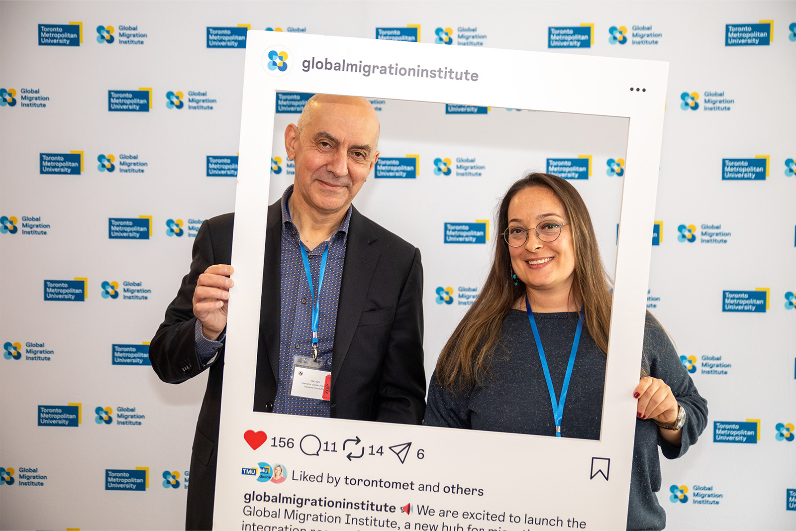Photo booth with two people holding a social media prop