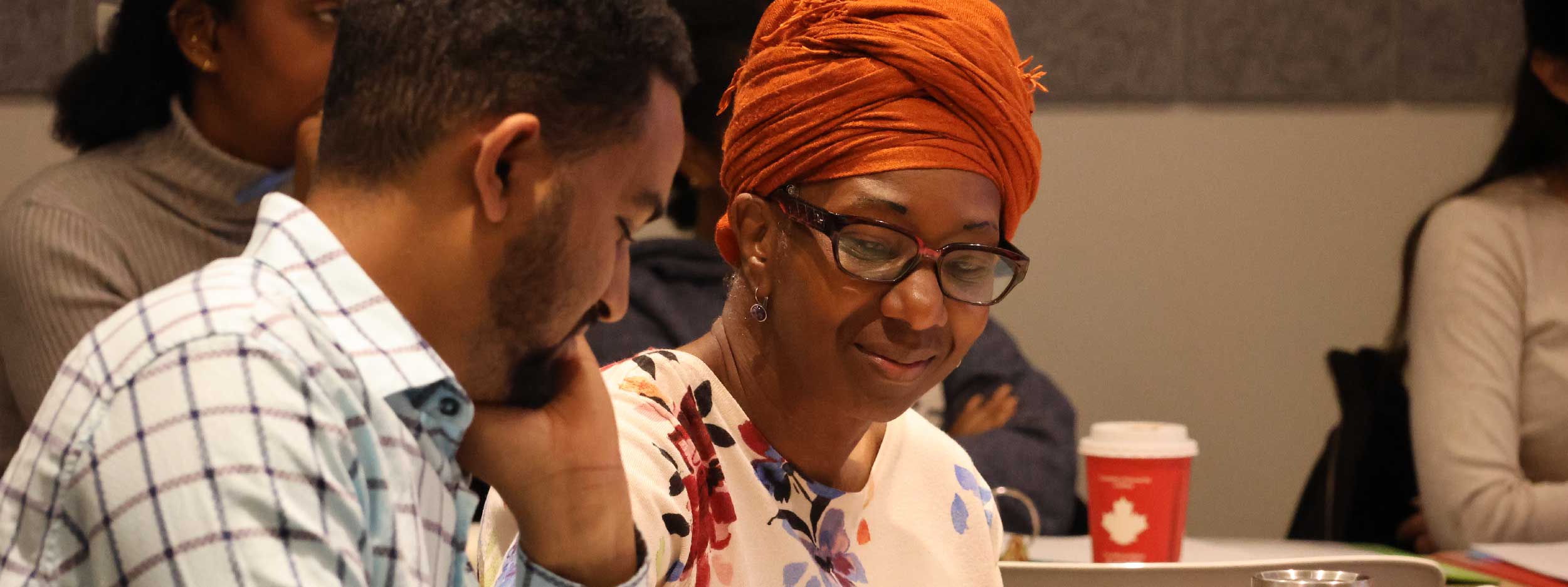 A man and a woman sitting at a workshop