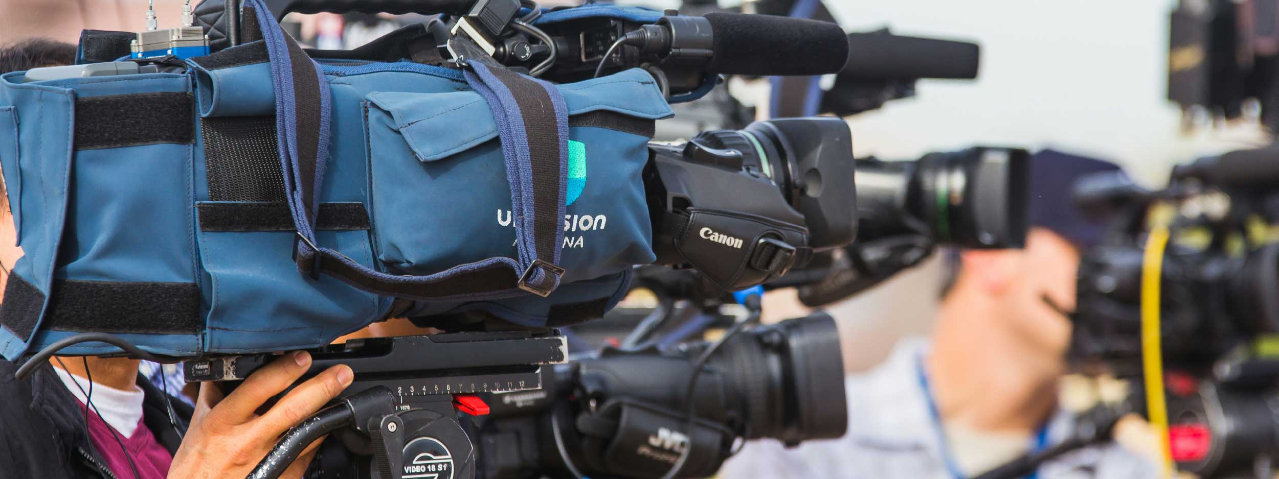 Media scrum with cameras on tripods