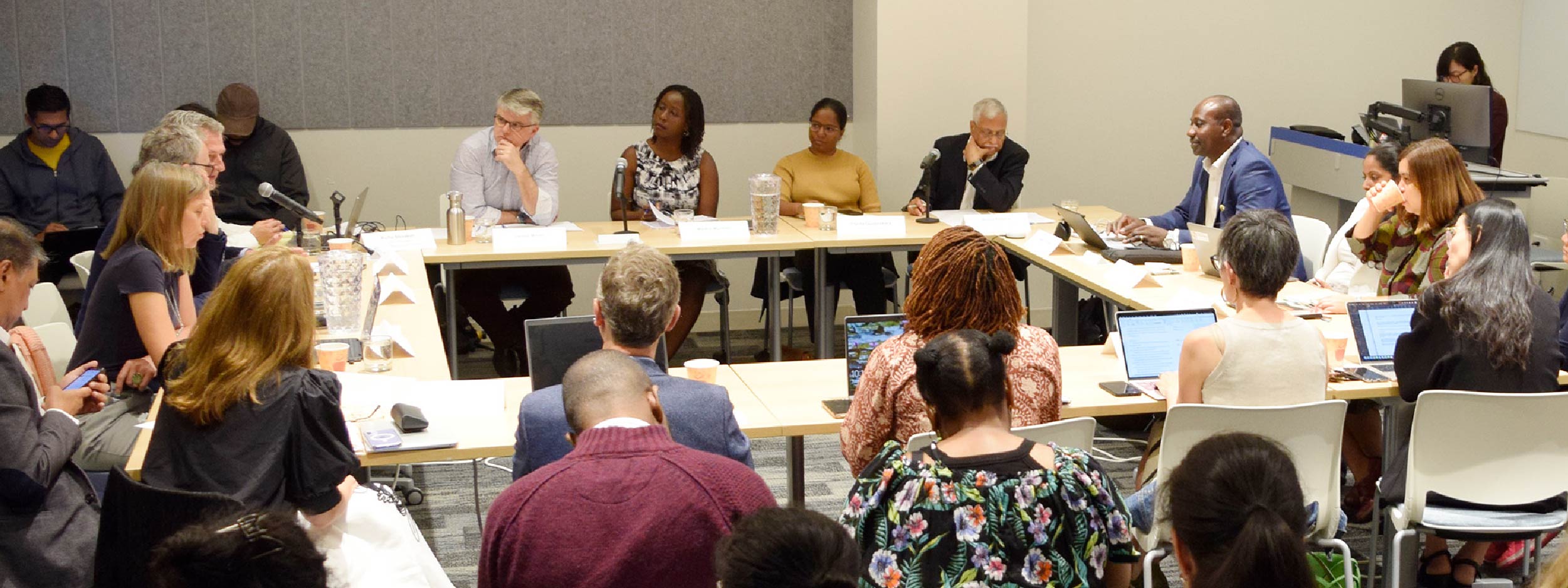 Conference room with people around a desk