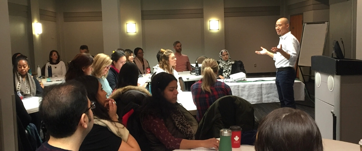 Dr. Wilson Leung speaks to an audience at a graduate student workshop.