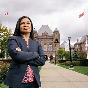 Female grad student standing in front of Queen's Park