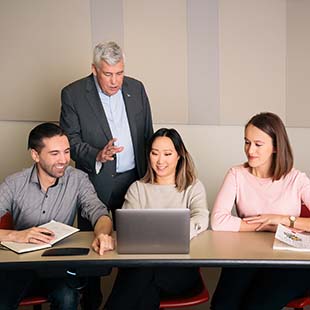 Director of Graduate Students Dr. Dale Carl coaches Ted Rogers MBA students Viktor Jonsson, Christina Ma and Ulana Mamalyga.