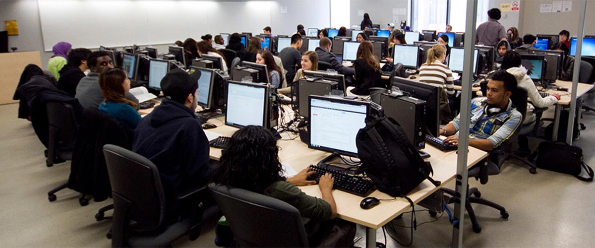 Students working at computer stations in a classroom
