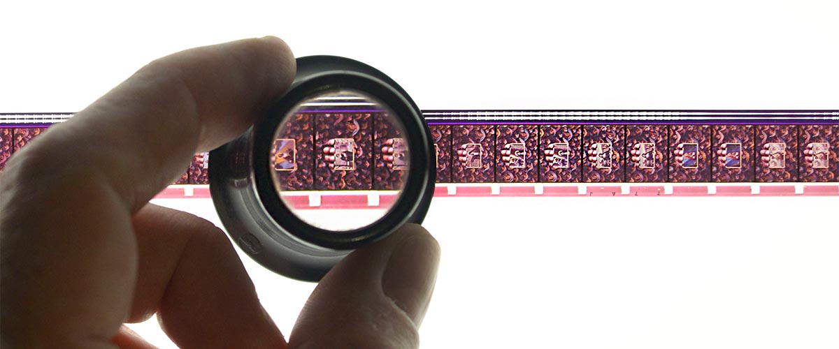 Student examining a negative photo reel