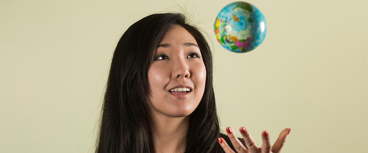 Student throwing a foam globe in the air