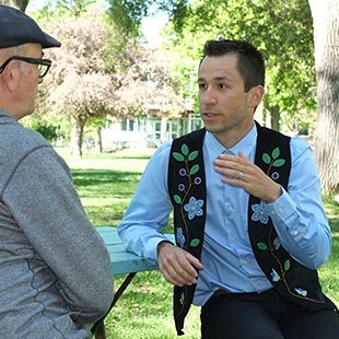 Réal Carrière talking with professor in TMU Quad