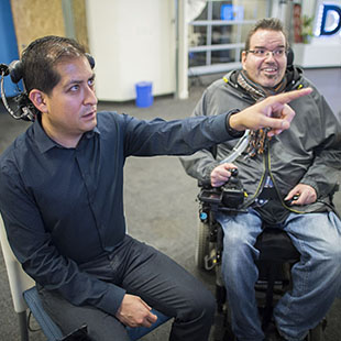 MBA-MTI alumnus Mauricio Meza demonstrates Tecla-e to user Neil Mercer