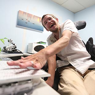 Dr. Colin Robert Phillips in his office using a computer