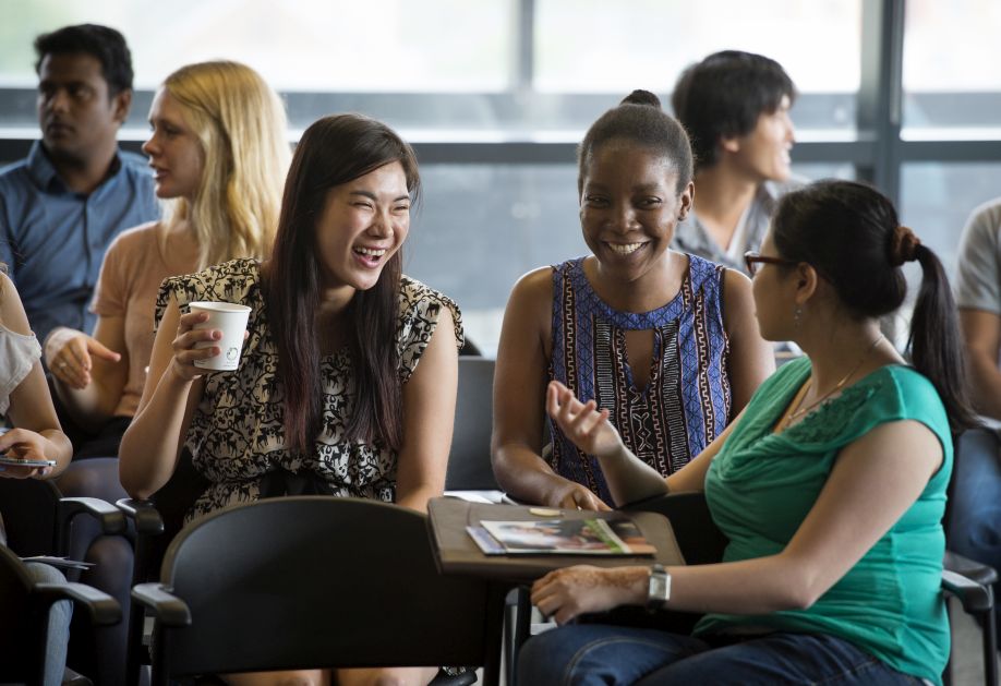 A group of students talking and laughing 