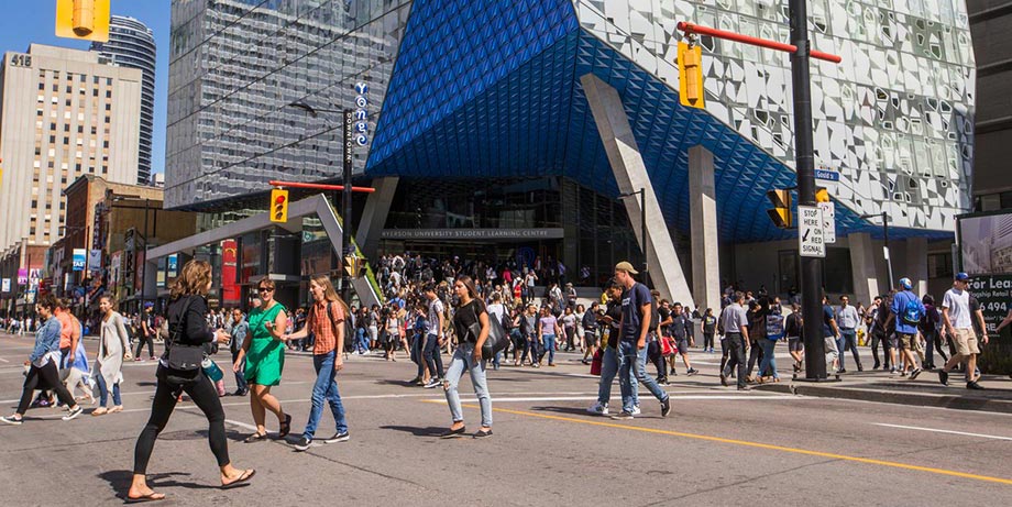 Pedestrians in front of Toronto Metropolitan University Student Learning Centre