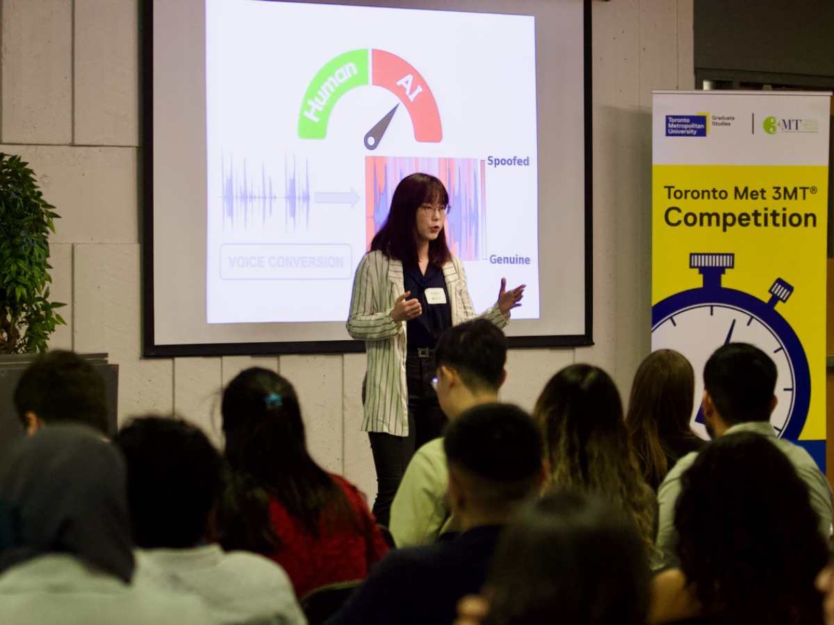 3MT participant presenting on stage in POD-250