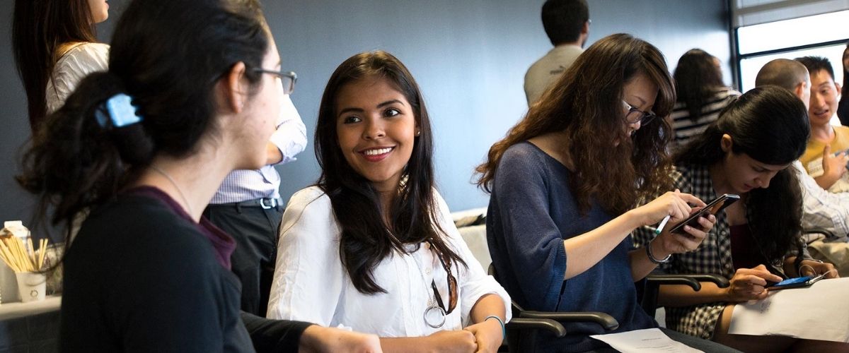 Graduate students talking at a networking event