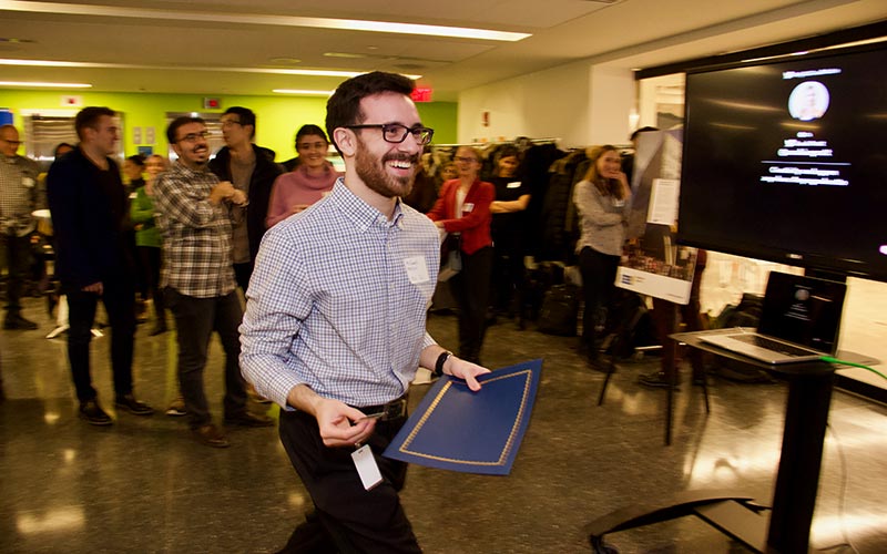 Grad student walks to receive his prize