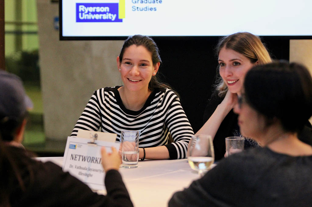 Andreaa Mihal and Angelique Bernabe listening to facilitator