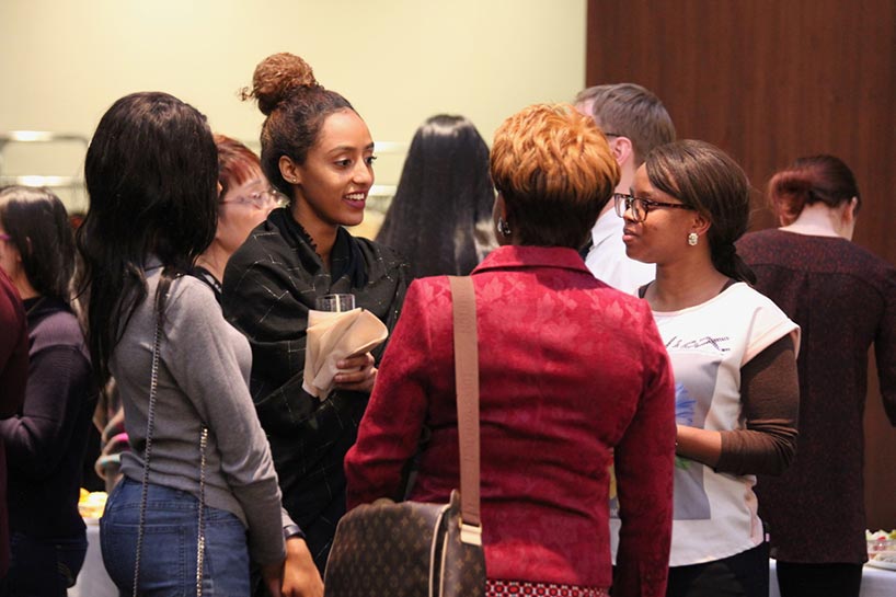 Graduate students talking during networking exercise