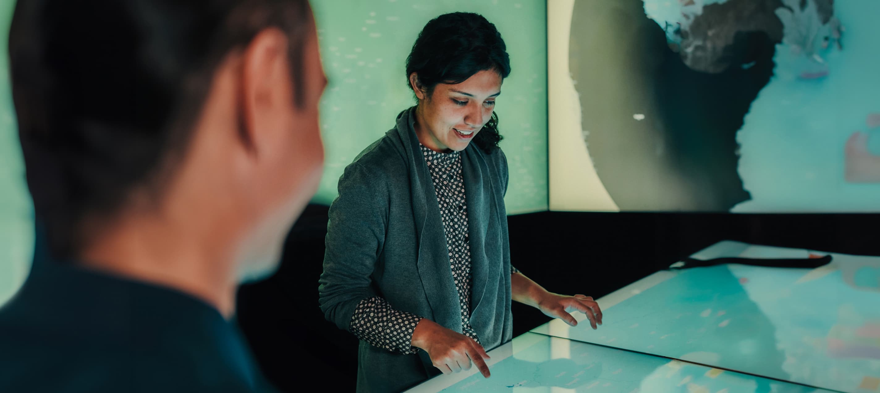 Graduate students using a digital interactive display.