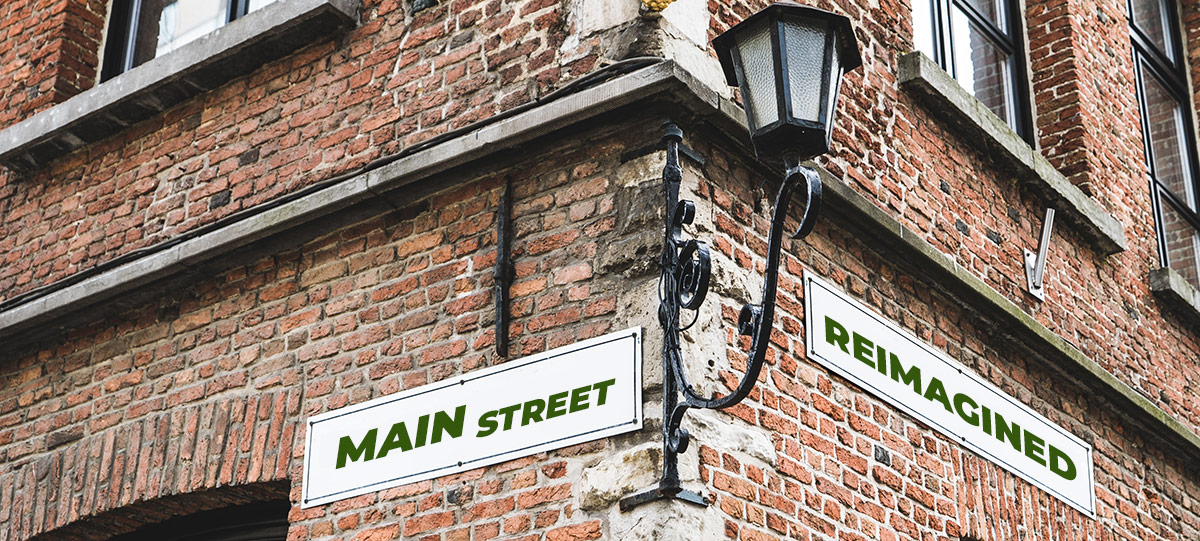 Main Street Reimagined signs on a corner of a street building