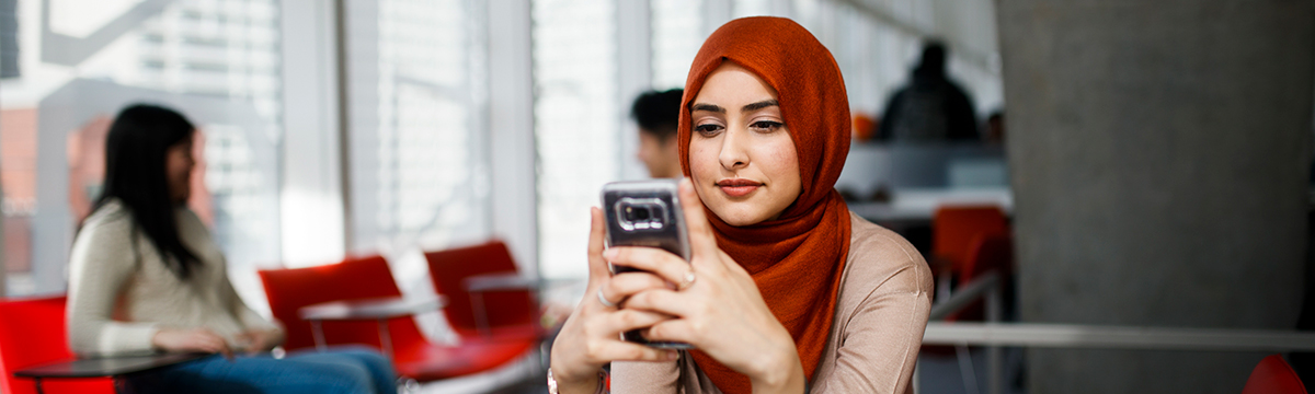 Toronto Met student in a hijab contacting Human Rights Services.