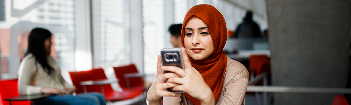 TMU student in a hijab contacting Human Rights Services.