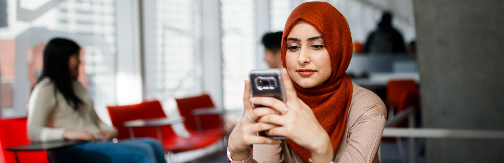 Ryerson student in a hijab contacting Human Rights Services.