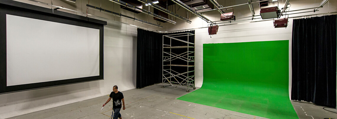 A large soundstage with green screen