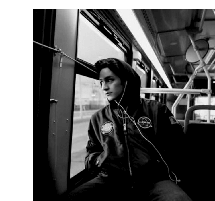 Still from Luke Galati's documentary film: young man sitting on a bus