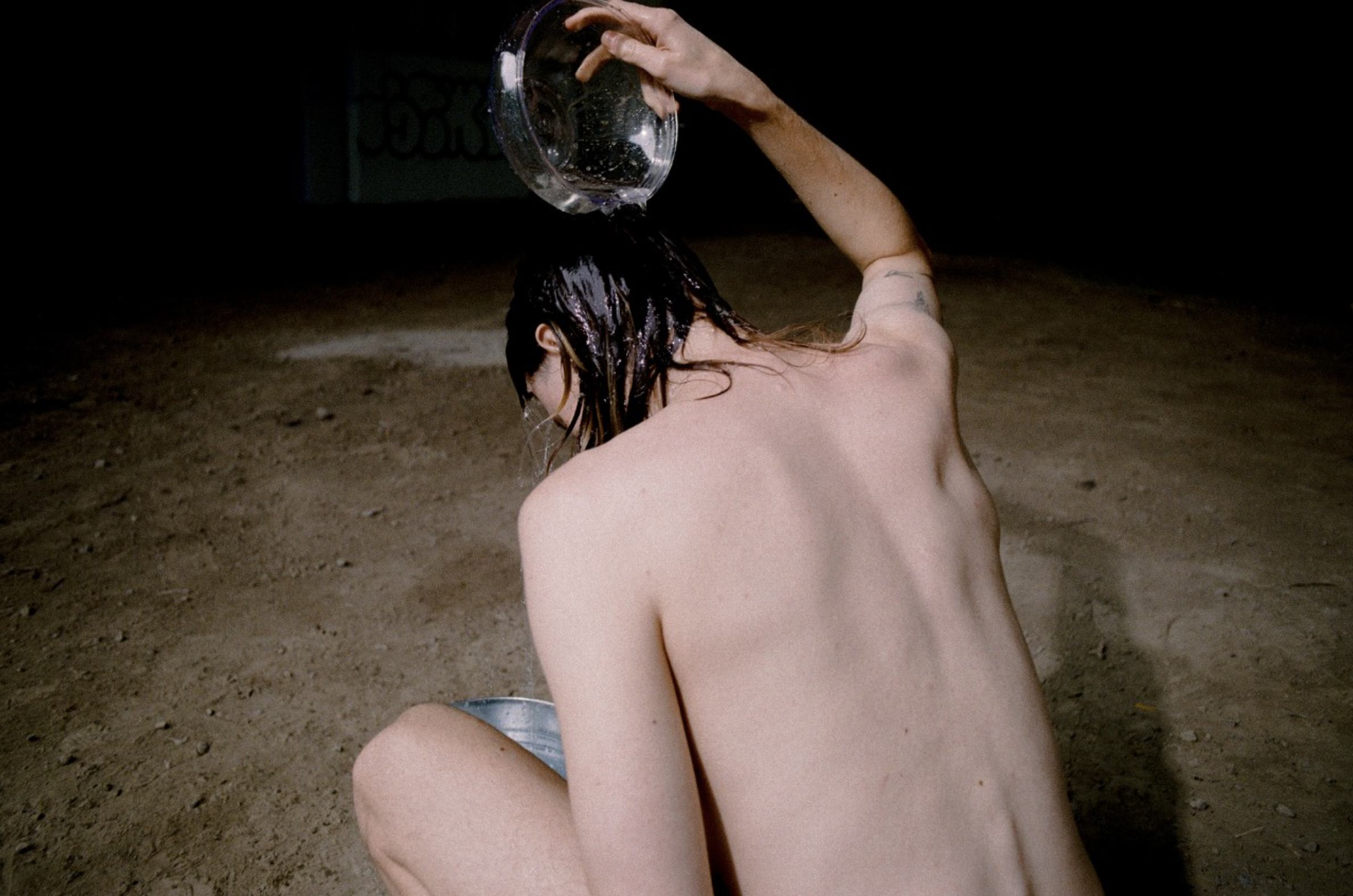 Person pouring water over their head, example of student photography