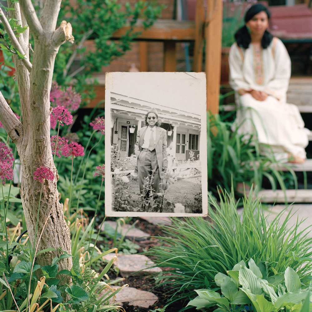 Old black and white image placed in a garden, with woman behind out of focus, example of student photography