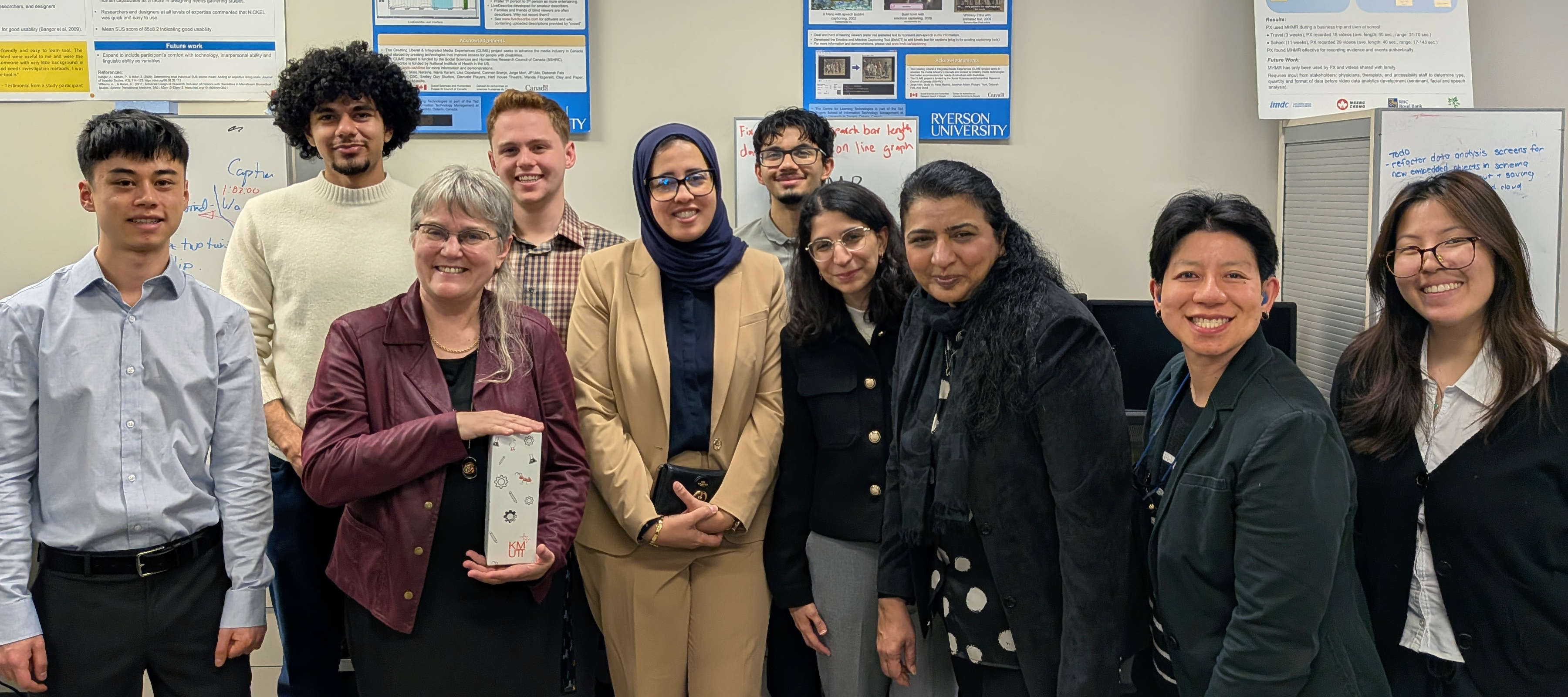 Dr. Fels and Dr. Ghenai with IMDC Students and Staff stand together after demonstrating their current projects