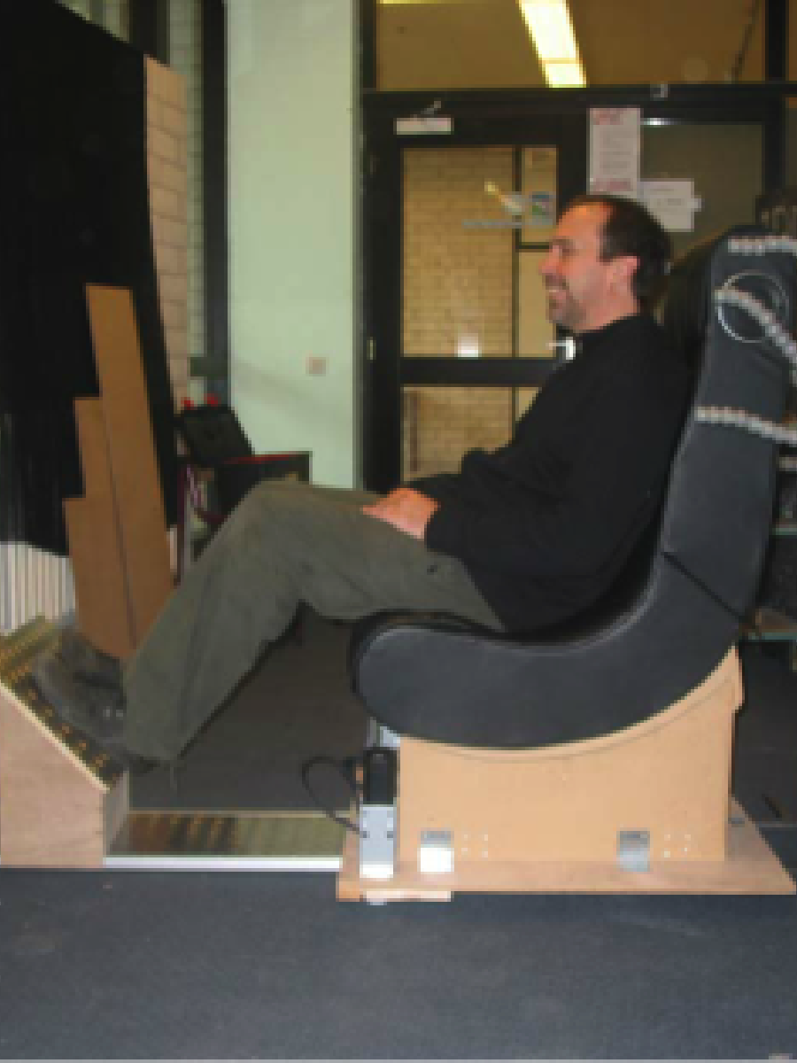 Artist, Graham Smith, sitting at a slight angle in his first Emotichair prototype.