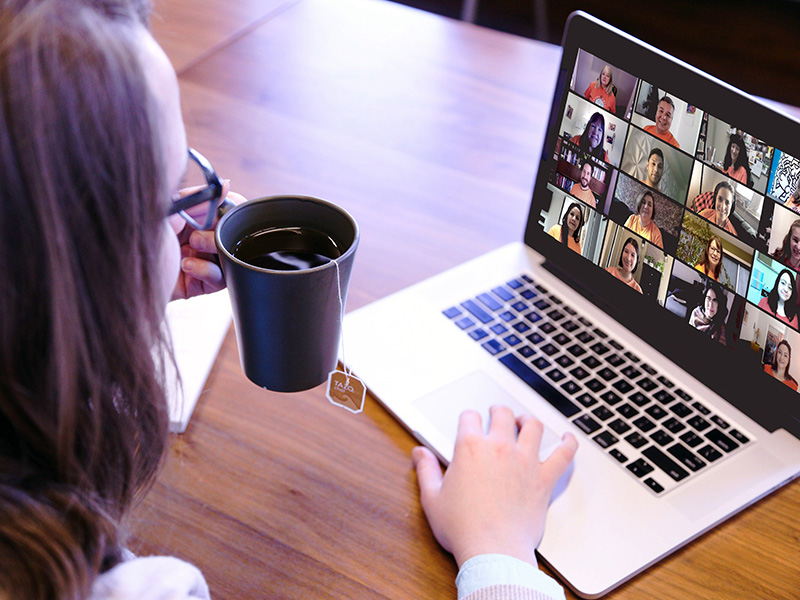 TMU student with a cup of tea on Zoom at a Tea n Talk event.