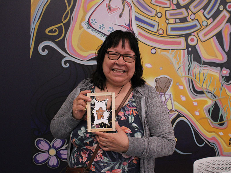 A participant with her artwork at the 2025 NIPM Inuit culture and art event.