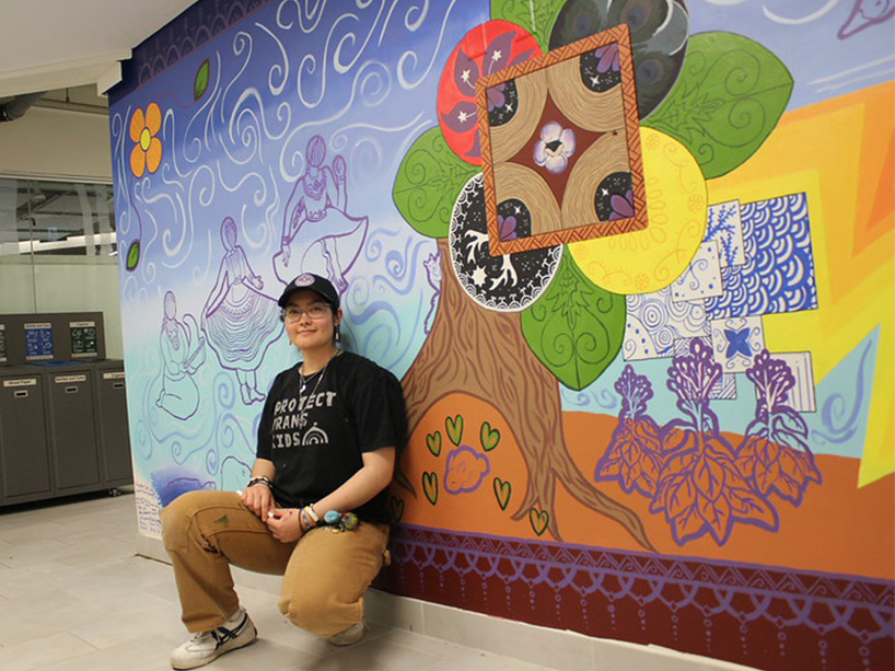 Giselle Del Vallé infront of colourful mural