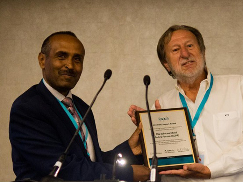 Two ACPF researchers displaying their award