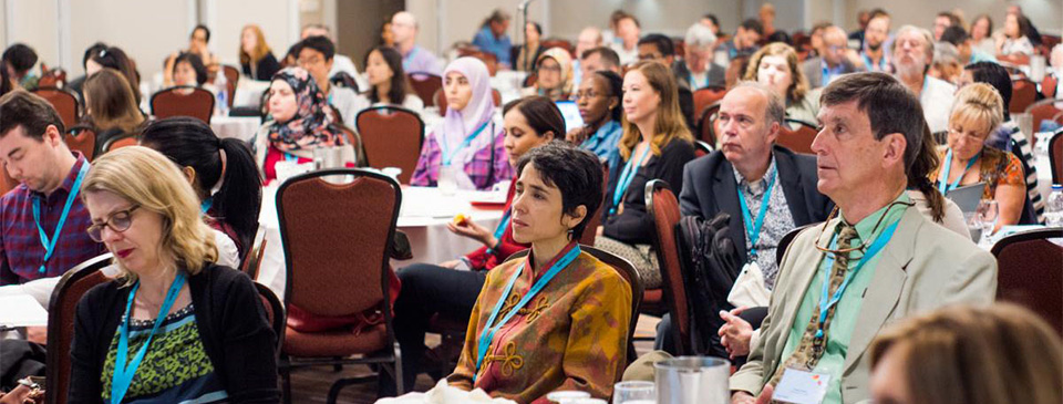 Attendees watching a presentation at the Montreal ISCI confrence